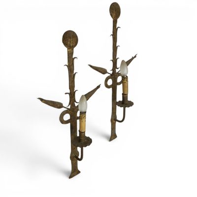 a pair of brass candles with birds on them on a white background