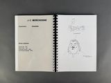 an open notebook with a drawing of a man ' s face on it