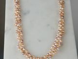 un gros plan d'un collier de perles posé sur une surface en marbre