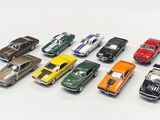 several toy cars are lined up in a row on a white surface