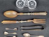 an assortment of silverware including spoons, forks, and glasses