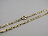 a close up of a gold chain with a clasp on it