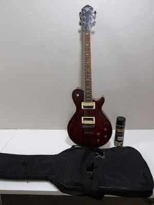 a guitar that is sitting on a table next to a guitar case