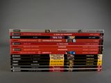 a lot of books that are stacked on top of each other