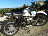 a motorcycle that is parked on a gravel road