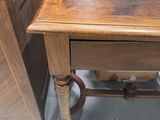 a wooden table with a drawer underneath it in a store