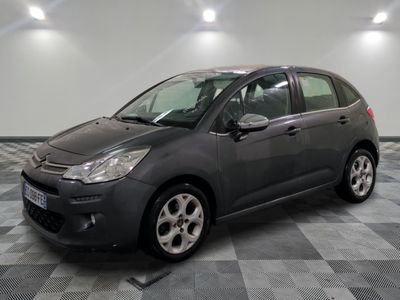 the grey citrole is parked on a checkered tile floor