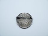 a close up of a silver coin with a bar in the middle