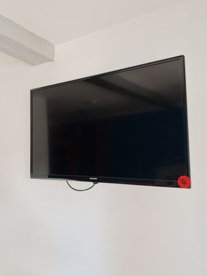 a flat screen tv mounted on a wall in a room