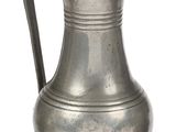 a silver pitcher with a handle on a white background