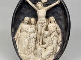 a black and white relief of jesus on the cross with three women