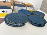 many discs of sand on a table next to a box of boxes