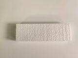 a close up of a piece of paper on a white surface