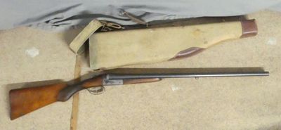 two shotguns are laying on the floor next to a bag