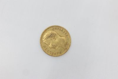 a gold coin on a white surface