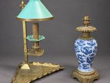 pair of blue and white vases and a lamp on a stand