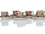 four coffee cups and saucers are lined up on a white surface