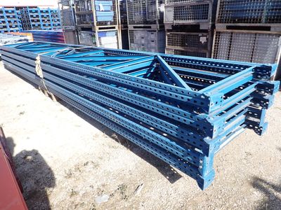 a close up of a pile of metal pallets in a warehouse