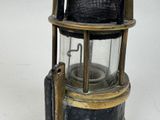 a black and gold light that is on top of a table