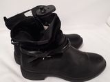 pair of black leather boots with buckles on a white background