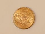 a close up of a gold coin on a white surface