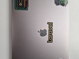 a laptop with stickers on the back of it