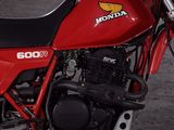 a red motorcycle that is parked in a garage
