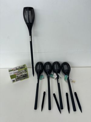 four black plastic spoons and four black plastic spoons on a white surface
