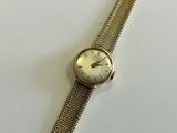 an image of a wrist watch sitting on top of a white table