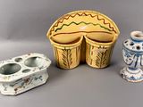 three small vases and a box on a table