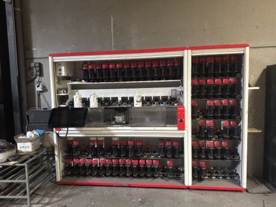 a large display of soda bottles in a building