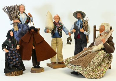 five figurines of people dressed in traditional clothing