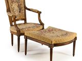 an image of a chair and foot stool with a floral upholstered seat