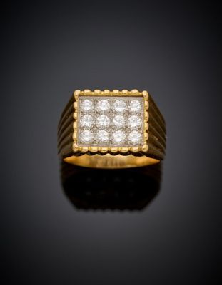 a yellow gold ring with diamonds on a black background
