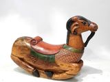 a small wooden horse with a saddle on it ' s back