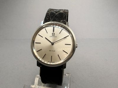 a watch that is sitting on a stand on a table