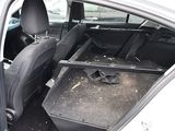 the back seat of a car with a broken tray in it