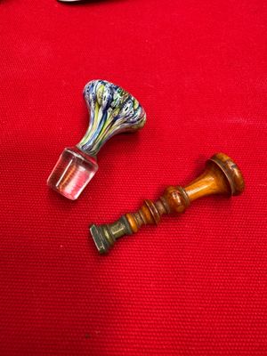 two pieces of glass sitting on a red cloth
