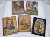 several old french travel books on a white surface