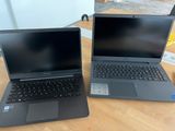 two laptops that are sitting on a wooden table