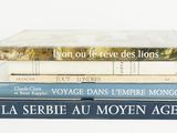 three books stacked on top of each other on a table