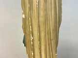statue of a woman in a gold dress holding a green umbrella