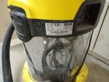 a yellow and black vacuum that is sitting on the floor