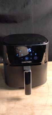 a black air fryer sitting on a wooden table