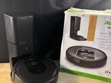 a box of a robot vacuum sitting on top of a wooden table