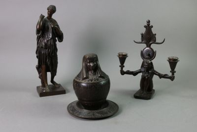 three bronze figurines that are sitting on a table