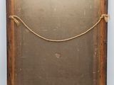 an old wooden frame with a rope hanging on it
