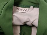 the back of a green jacket with a white label on it