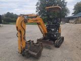 an image of a small excavator parked in the dirt