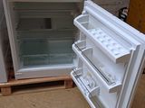 two refrigerators that are sitting on pallets in a room